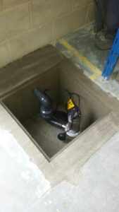 A Lakeside sump and pump system being used to stop a garage from flooding